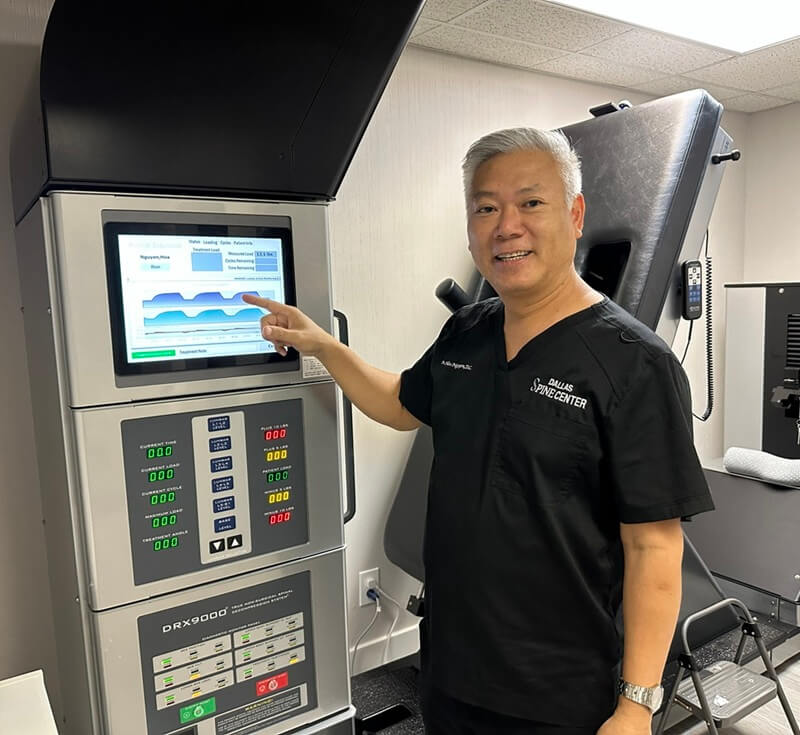 Dr. Hoa Nguyen with the DRX9000 spinal decompression table in Carrollton, TX